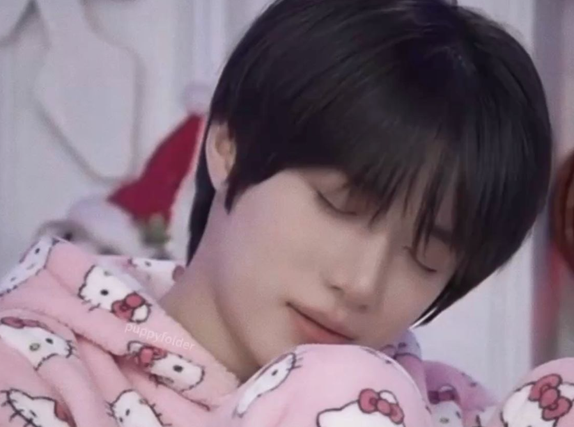 not the webmaster, but instead it is a picture of 
Beomgyu from TXT hugging his knees to his chest and sleeping.